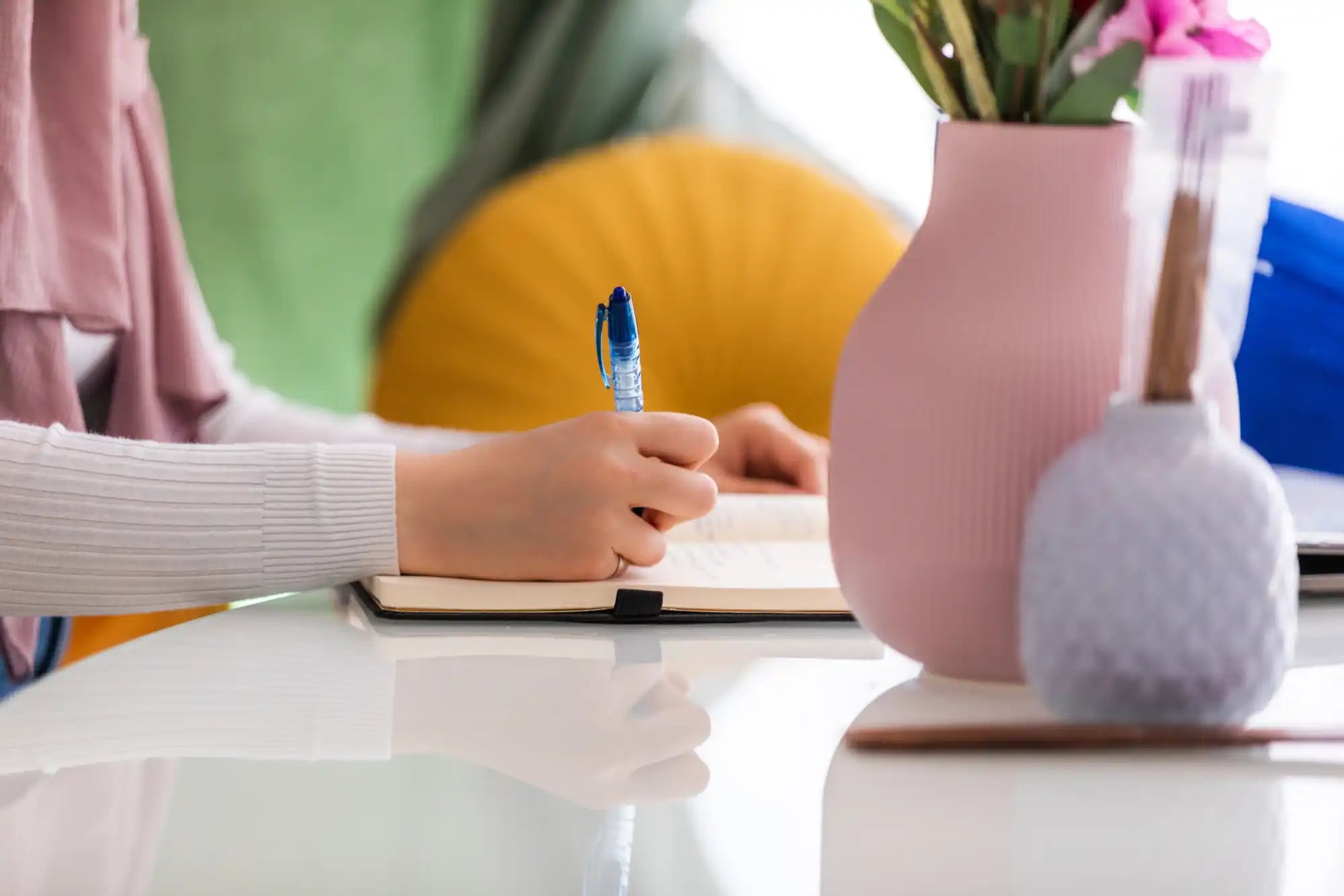 Person writing in a notebook.